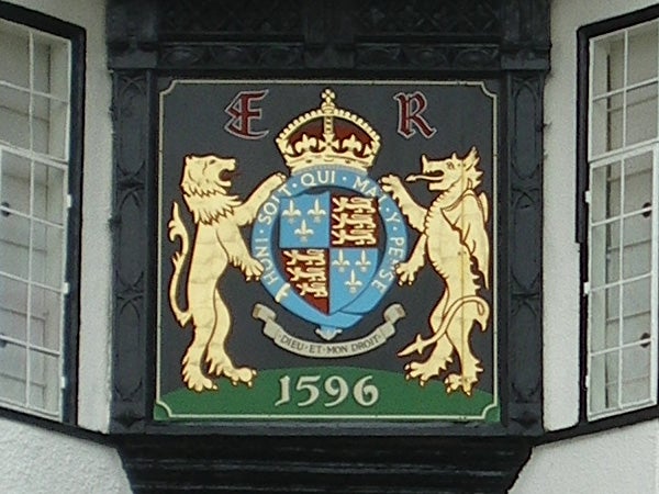 Decorative plaque with lions and a shield displaying a date from 1596.