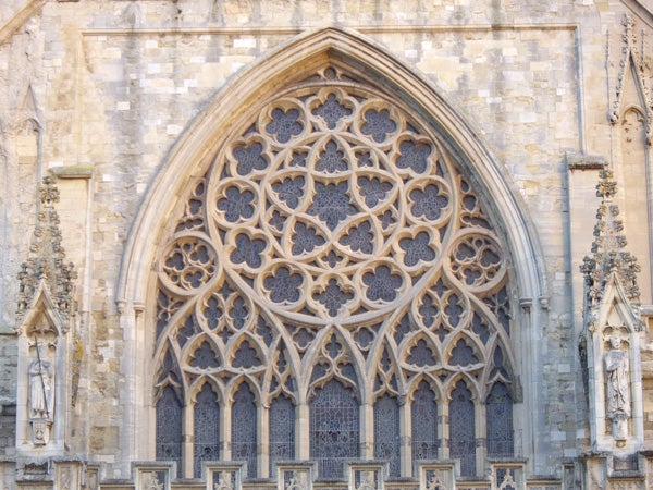 Intricate gothic window architecture with stone tracery