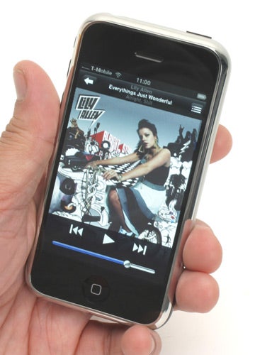 Hand holding an Apple iPhone displaying music album cover.