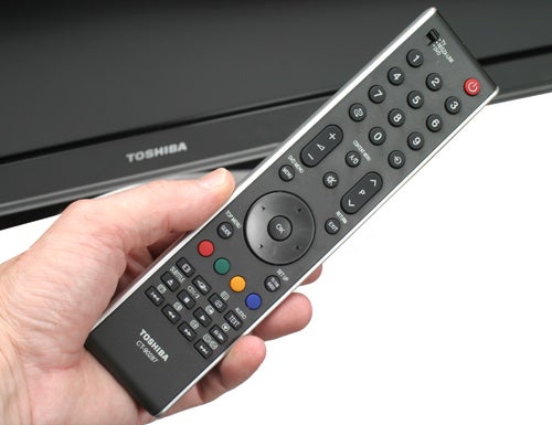 Hand holding a Toshiba Regza TV remote control.