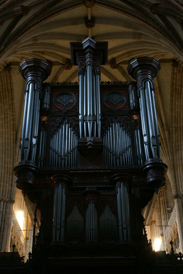 Large pipe organ in a cathedral's interior.
