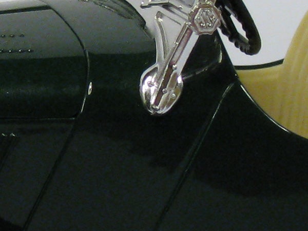 Close-up photo of a shiny black shoe with a keyring.