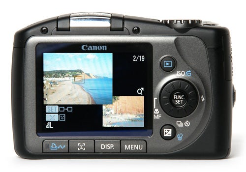 Canon PowerShot SX100 IS camera showing LCD screen and buttons.