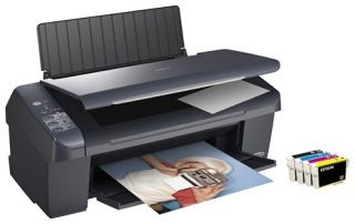 Epson Stylus DX4400 printer with printed photo and ink cartridges.