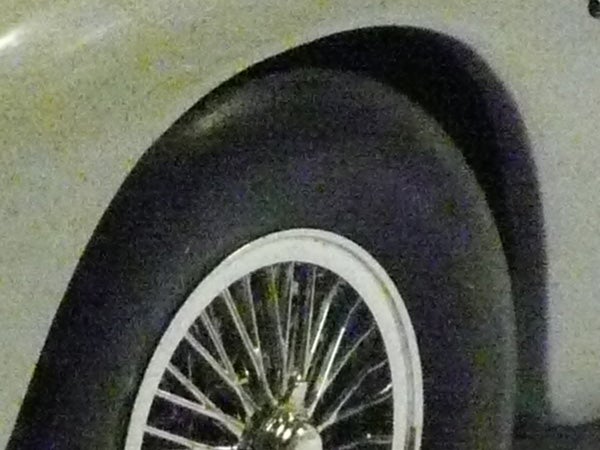 Close-up of a car wheel with chrome spokes.