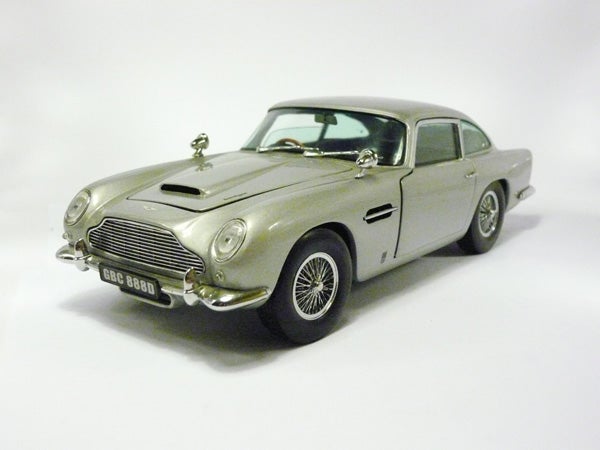 Silver Aston Martin model car on a white background