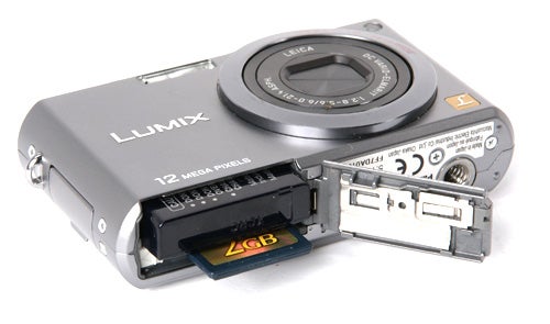 Panasonic Lumix DMC-FX100 camera with open memory card slot.