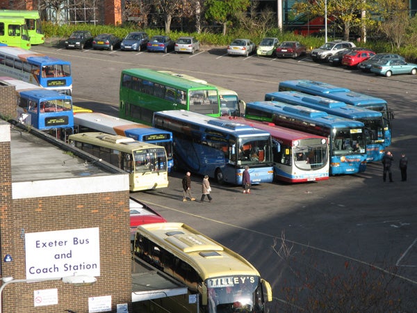Photo taken with Canon PowerShot A720 IS of buses at a station.