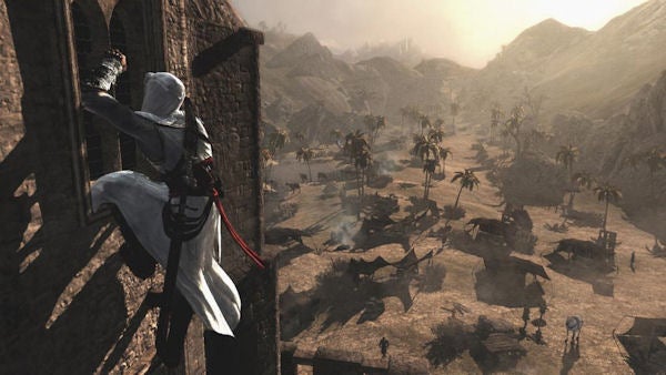 Assassin's Creed character climbing a wall with desert landscape.