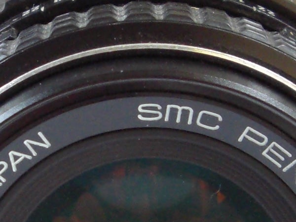 Close-up of camera lens with brand lettering.Close-up of a camera lens with brand inscription.