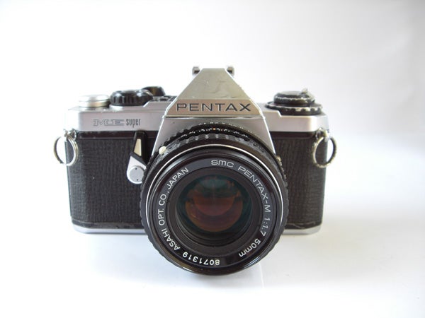 Vintage Pentax film camera on white background.Vintage Pentax film camera on a white background