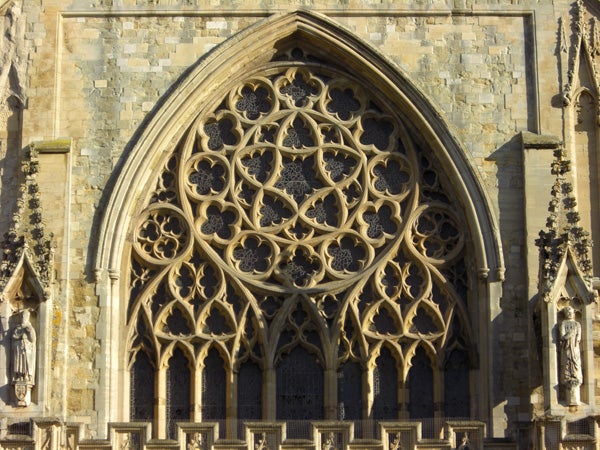 Gothic architectural detail of a cathedral's rose window.Detailed stone archway on a cathedral facade.