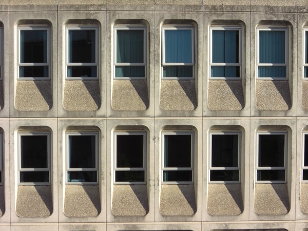 Patterned facade of a building with multiple windows.Pattern of windows on an office building facade.