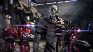 Mass Effect character with red robotic enemies in game scene.