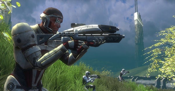 Character from Mass Effect aiming a weapon in a grassy area.Character from Mass Effect aiming a gun in a grassy area.