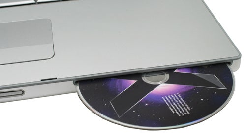 Apple MacBook Pro 17-inch with optical drive open.Apple MacBook Pro 17-inch with CD drive open and disc.
