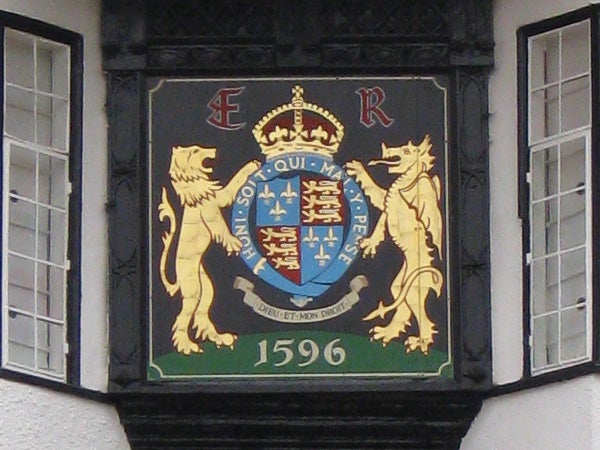 Coat of arms on building facade dated 1596.Close-up photo of a regal crest with lions from 1596.