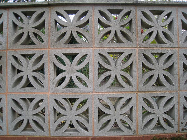 Decorative concrete block wall with a floral pattern design.Decorative concrete block wall with geometric patterns.