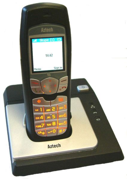 Aztech IP phone on charging dock displaying Skype interface