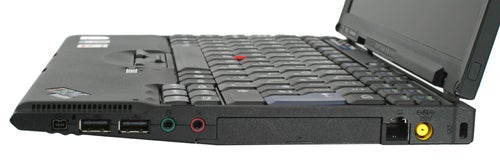Lenovo ThinkPad X61s laptop showing keyboard and ports.Lenovo ThinkPad X61s laptop with ports visible on side.
