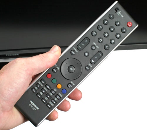 Toshiba Regza TV remote control held in a person's hand.Toshiba Regza TV remote control in hand