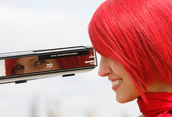 Woman with red hair reflecting in Sharp Blu-ray player.