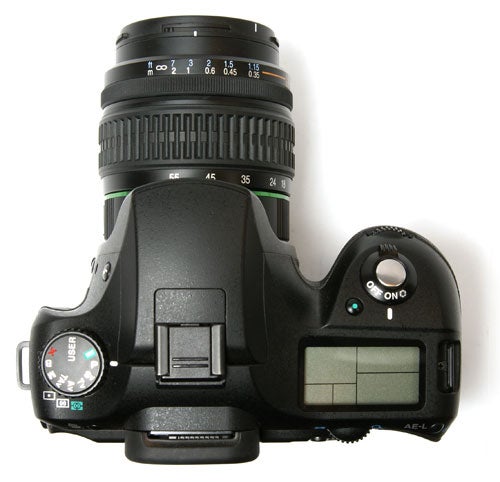 Pentax K10D DSLR camera with mounted lens viewed from above.Pentax K10D DSLR camera with attached lens viewed from above.