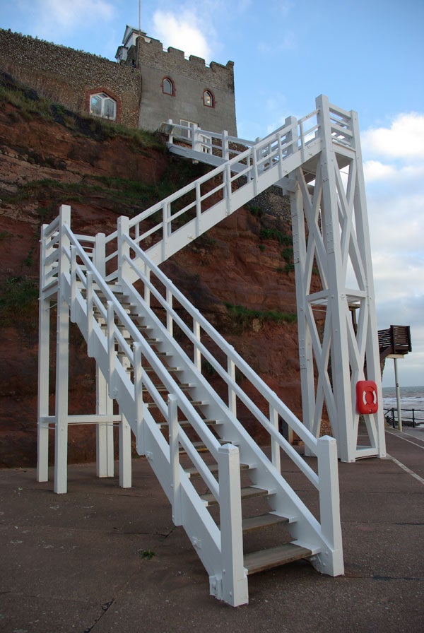 White staircase leading to a house on a cliff.White staircase leading up to a building on a cliff.