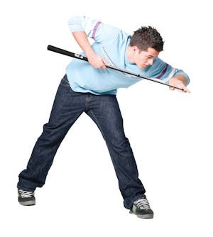 Person demonstrating a golf swing with a game controller.
