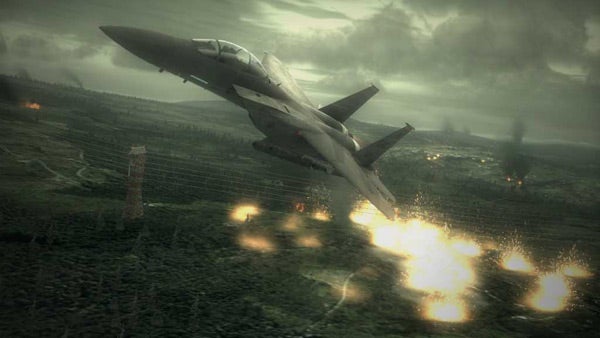 Fighter jet flying low over battlefield in Ace Combat 6 game.Screenshot of Ace Combat 6 gameplay featuring a jet aircraft.