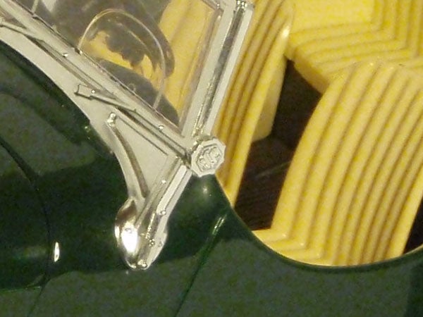 Close-up shot of a camera lens and partial body.Close-up photo of reflective metallic and glass surfaces.