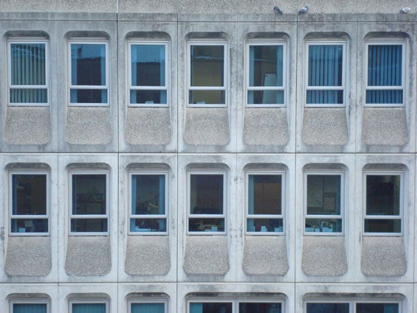 Photo of building facade with multiple windows.