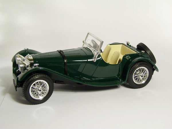 Green vintage car model on a white background.