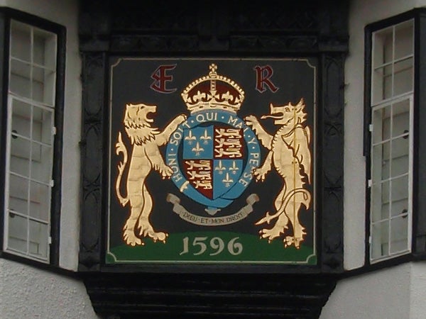 Coat of arms plaque with lions and crown, dated 1596.Photo of an ornate heraldic plaque with lions and a crown