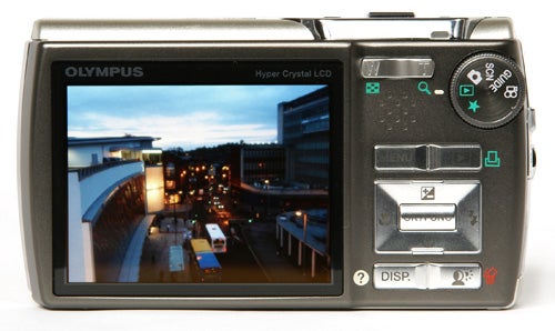 Olympus mju 830 camera displaying a night scene on LCD screen.Olympus mju 830 camera with evening cityscape on display screen.