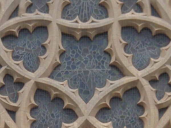 Olympus mju 830 camera sample of architectural detailsGothic stone window tracery patterns with blue sky background.