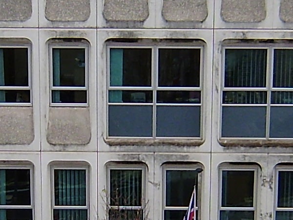 Photograph of a building facade with multiple windows.Photo of building facade with multiple windows taken with Olympus FE-290.