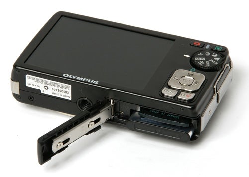 Olympus FE-290 camera with open battery compartment.Olympus FE-290 digital camera with open battery compartment.
