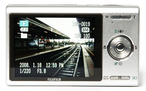 Fujifilm FinePix Z100fd camera with displayed photo of train station.Fujifilm FinePix Z100fd digital camera displaying a photo on screen.