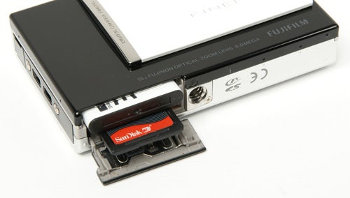 Fujifilm FinePix Z100fd camera with open memory card slot.Fujifilm FinePix Z100fd camera with open battery compartment