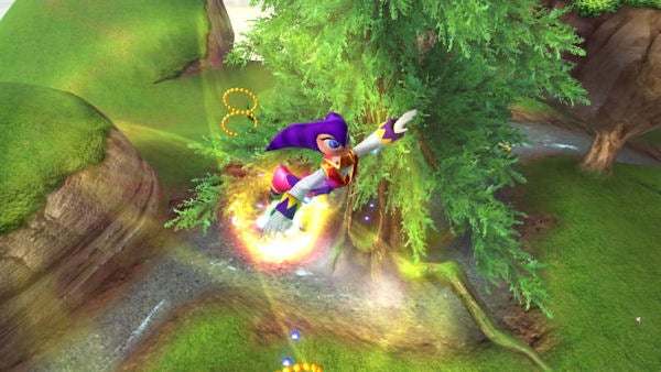 Screenshot of NiGHTS flying in Nights: Journey of Dreams game.Character flying over a forest in Nights: Journey of Dreams game.