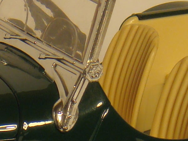 Close-up of a vintage car's chrome windshield wiper and detailClose-up of a vintage car's side mirror and details