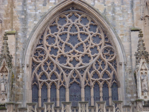 Detailed close-up of a cathedral's ornate window facadeClose-up of intricate gothic church window architecture.