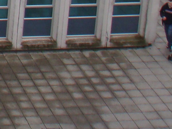 image of a tiled roof and windows, possible camera shake.Blurred photo of a building's windows and roof.