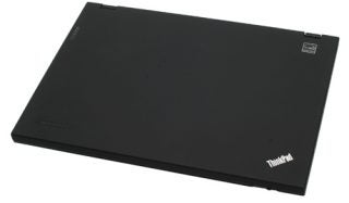 Closed Lenovo ThinkPad laptop on white background.