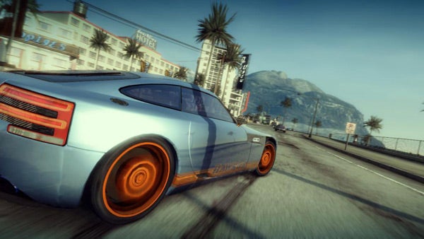 Blue sports car racing in Burnout: Paradise game.