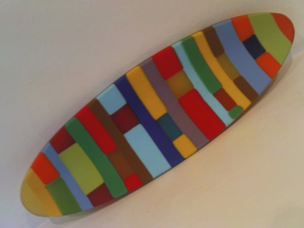 Colorful surfboard-shaped object on white background