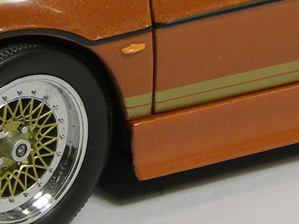 Close-up of a toy car wheel and body detail.