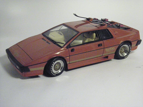 Model of a red sports car with open gull-wing doors.