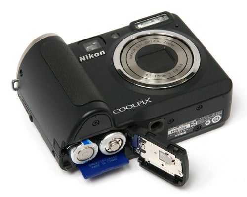 Nikon CoolPix P50 camera with open battery compartment.